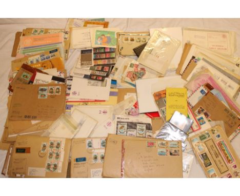 A box containing a large selection of various GB and British Commonwealth postal covers, first day covers, packets of stamps,