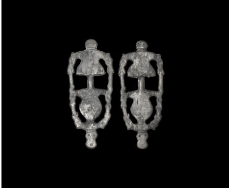 7th century AD.
A matched pair of silver openwork bow brooches, each a D-shaped headplate with flat bow, addorsed horse-heads