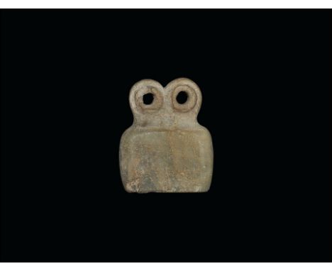 3rd millennium BC. 
An alabaster bifacial idol, flat in section, with trapezoidal body and two large pierced and rimmed eyes 