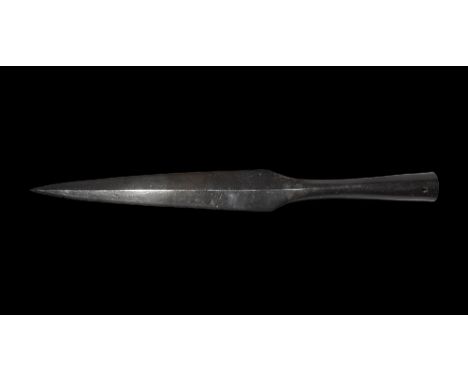9th-11th century AD.
A long iron spearhead with lozenge-section tapering blade, short neck, long flared closed socket with fi