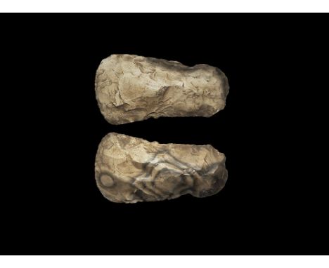 Neolithic, 4th-2nd millennium BC.
A knapped handaxe in patterned flint with rounded butt and broad curved and chamfered cutti