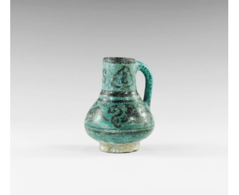 13th century AD. 
A turquoise-glazed ceramic jug with biconvex body, flared base, tubular neck and round-section strap handle