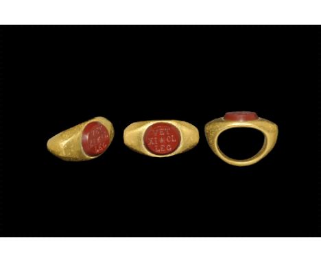 3rd century AD. 
A gold D-section hoop with expanding shoulders, flat scaphoid plaque with inset carnelian, intaglio inscript