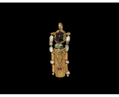 2nd-3rd century AD. A gold composite pendant comprising a tubular case with repousse facing mask, bands of granulation, inset