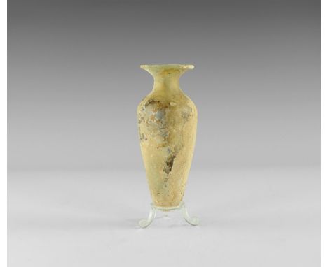 2nd-3rd century AD. 
A glass flask with tapering conical body and rounded base, deep shoulder, broad flared neck with folded 