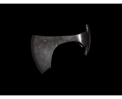 9th-11th century AD. 
An iron axehead with triangular-section blade widening to a broad bevelled edge with square chin and sp