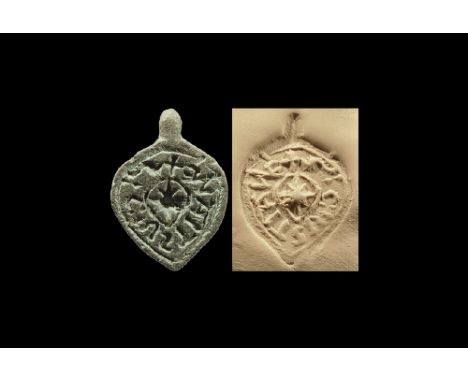 12th-14th century AD. 
A lead-alloy heart-shaped pendant pierced to the centre with suspension lug; intaglio text 'S: C: IVST