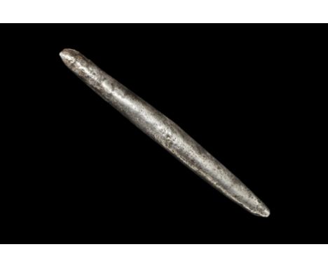 9th-11th century AD. 
A large cast ingot, D-shaped in section with smooth underside; punched rosette of points to the upper f