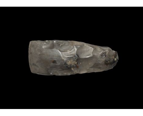 Neolithic, 6th-2nd millennium BC.
A large finely knapped and polished axehead with slightly convex cutting edge, near paralle