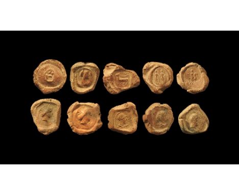 1st-3rd century AD.
.A mixed group of discoid ceramic theatre tokens or seals with impressed motifs from intaglio matrices, m