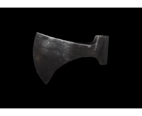 9th-11th century AD. 
An iron axehead with triangular-section blade widening to a broad bevelled edge, socket with flange to 