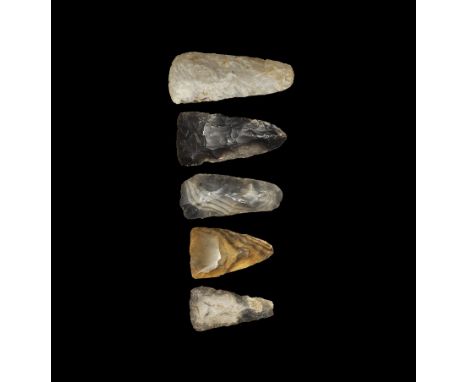 Neolithic, 5th-3rd millennium BC. 
A mixed group comprising: a large axe with tapered sides, rounded butt and slightly convex