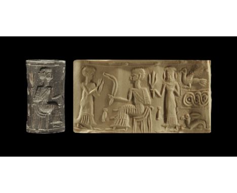 1950-1550 BC. 
A haematite cylinder seal with a male figure in long robes, hands raised in prayer, before a seated male figur