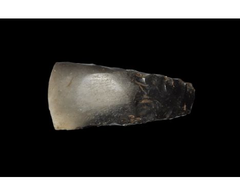 Neolithic, 6th-2nd millennium BC. 
A carefully knapped and polished axehead with slightly convex cutting edge, near parallel 