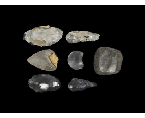 Palaeolithic to Neolithic, 600,000-3,000 years BP.
A mixed group of stone implements comprising: a bifacial triangular handax