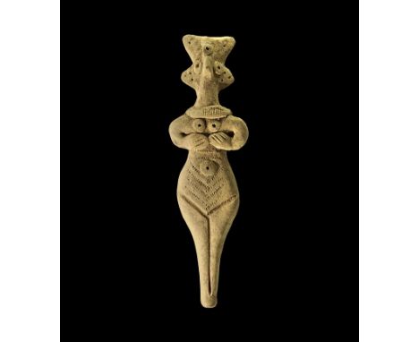 1180-700 BC. 
A buff coloured ceramic figure of a nude female, hands to the breasts, schematic face with pinched nose and app