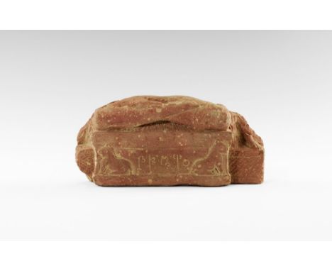 2nd-4th century AD. 
A red sandstone statue base with crossed legs of Buddha above a hatched field with addorsed lions, five 