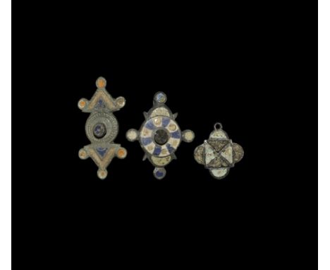 2nd century AD. 
A mixed group of bronze plate brooches with polychrome enamel detailing, one with loop to the lower edge. 24