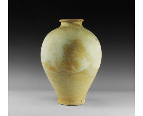 Tang Dynasty, 618-906 AD.
A large piriform ceramic jar with tubular neck and everted rim, soft glaze with scalloped edge to t