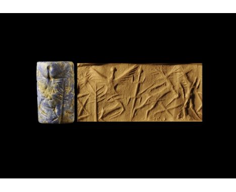 2nd millennium BC.
A carved lapis lazuli cylinder seal with a frieze of a bird in flight with spread wings, a leaping stag, a