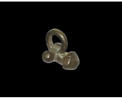 1st-2nd century AD.
An unusual type of bronze phallic pendant with loop above, testes to the sides. 13 grams, 24mm (1").[.No 