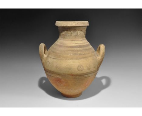 8th-6th century BC. 
A broad globular ceramic vessel with flared base, slightly funicular neck, thick chamfered rim, two roun