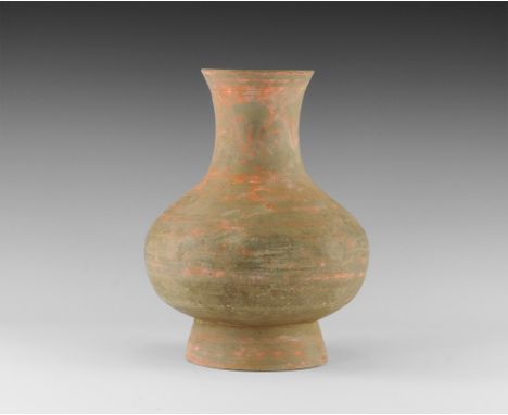 Han Dynasty, 206 BC-220 AD. 
A bulbous ceramic jar with flared base and waisted neck, bands of painted red geometric decorati