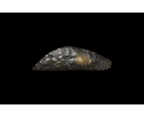 Neolithic, 4th-3rd millennium BC. 
A large bifacially knapped knife with curved back and straight cutting edge; the edge serr