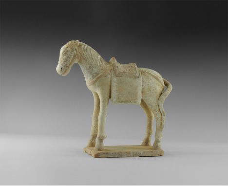 Ming Dynasty, 1368-1644 AD.
A buff ceramic statuette of a sturdy horse standing on a rectangular base with bridle and harness