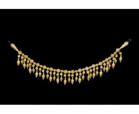 4th-3rd century BC. 
A restrung necklace consisting of a single row of fifteen spherical hollow gold beads with articulating 