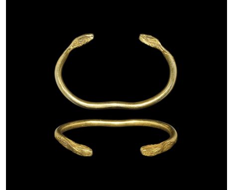 4th century BC. 
A round-section gold penannular bracelet with slight recurve to the underside, square-section finials formed