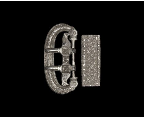 4th-5th century AD. A silver belt suite comprising: a broad flat-section loop with opposed beast-heads, raised band with runn