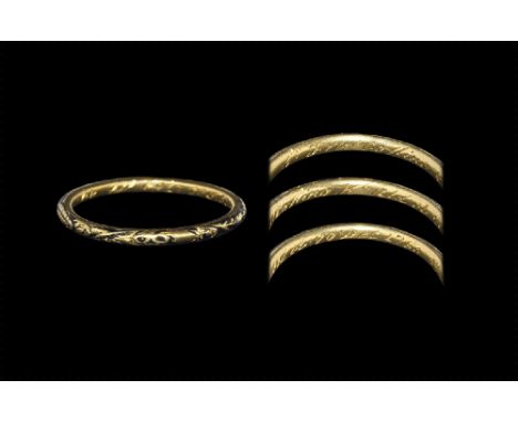 Dated 29 December 1768 AD. 
A narrow D-section gold hoop, the outer surface engraved with a floral design reserved against bl