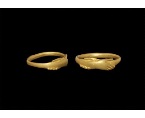 15th century AD. 
A narrow gold hoop with bezel formed as two clasped hands. 2.20 grams, 18mm overall, 15.59mm internal diame