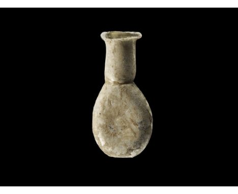 2nd-3rd century AD.
A small pale blue flask with oval body, tapering in profile, tubular neck and iridescent surface. 10 gram