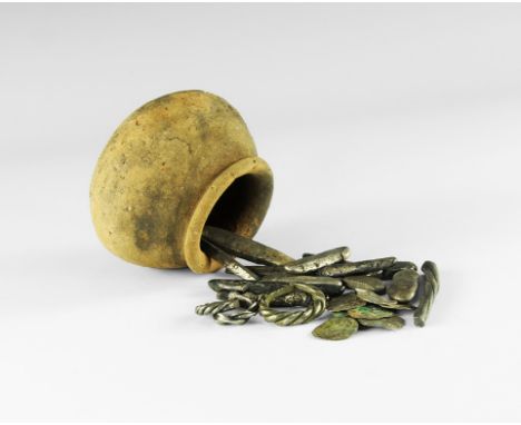 9th-11th century AD. 
An assemblage of Viking silver 'hack', with a ceramic pot comprising: two finger-rings with faux-twist 