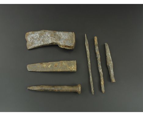12th-15th century AD. 
A mixed group of iron tools comprising: a small axehead; a woodworking wedge; two square punches; two 