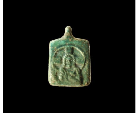 19th-20th century AD. A blue-glazed ceramic plaque with pierced lug above, raised image of a bearded Christ holding a cross w