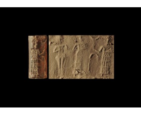 2nd millennium BC.
A serpentine(?) cylinder seal with frieze of two standing figures in flounced robes with staff between and
