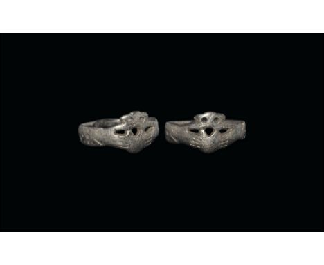 17th-18th century AD.
A flat-section silver hoop with bezel formed as two hands gripping a crowned heart. 3.69 grams, 22mm ov