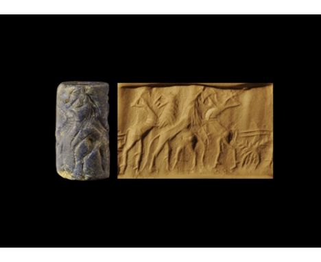 2nd millennium BC.
A carved lapis lazuli cylinder seal with frieze of two pairs of opposed rampant animals with vegetation. 6
