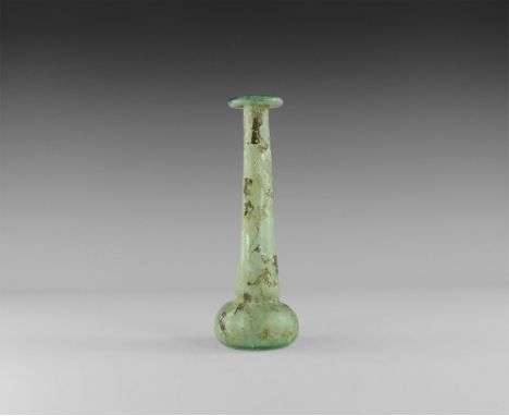 2nd-3rd century AD.
A blue glass vessel with broad conical base and recessed underside, tapering tubular body with everted an