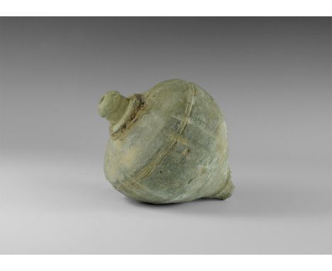 9th-11th century AD. 
A hollow ceramic vessel with a thick conical nozzle, broad shoulder with incised bands, piriform body w