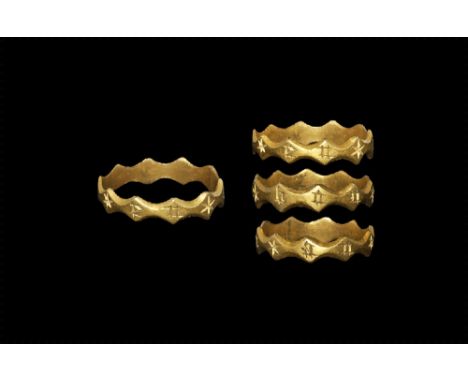 14th-15th century AD. 
A flat-section gold hoop with scalloped and chamfered edges, incised blackletter text in Latin to the 
