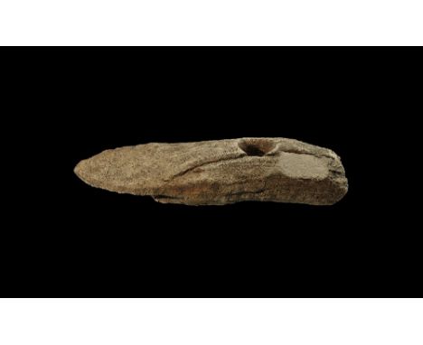 Neolithic, 4000-2500 BC.
A bone or antler axehead, flat butted and with tapering end, socket hole through the body. 335 grams