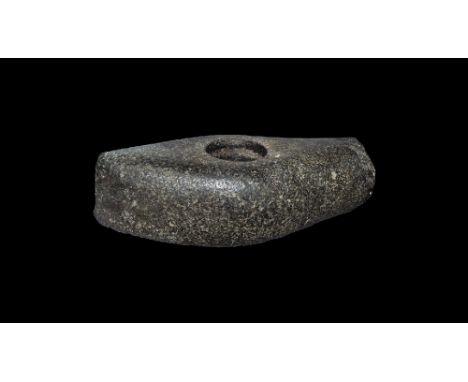 Neolithic, 4th-2nd millennium BC.
A ground diorite axehead with median swelling, round mounting hole, square-section hammer b