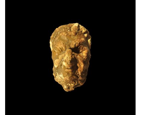 15th-16th century AD. 
A gesso corbel or architectural moulding of a human mask with deep-set eyes, aquiline nose and puckere