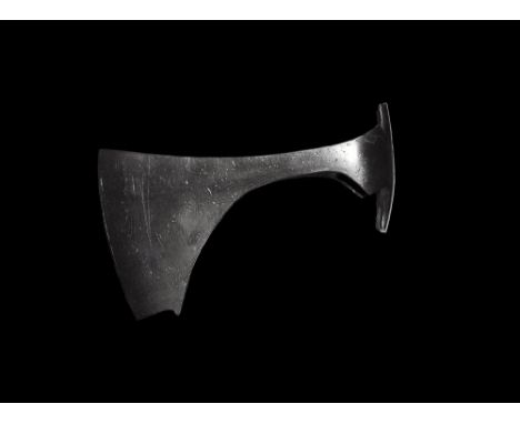 9th-11th century AD. 
An iron axehead with triangular-section blade, narrow neck widening to a broad bevelled edge with squar