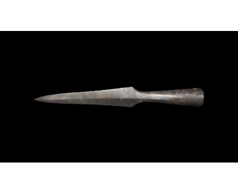 9th-11th century AD.
An iron spearhead with lentoid-section tapering blade and midrib, short neck, long flared closed socket 