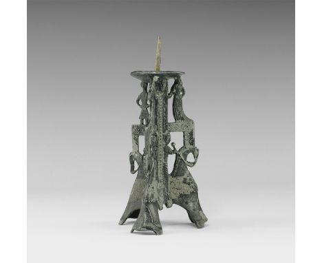 14th-15th century AD. 
A tall openwork moulded pewter candlestick with three legs, each formed of a knight on horseback with 